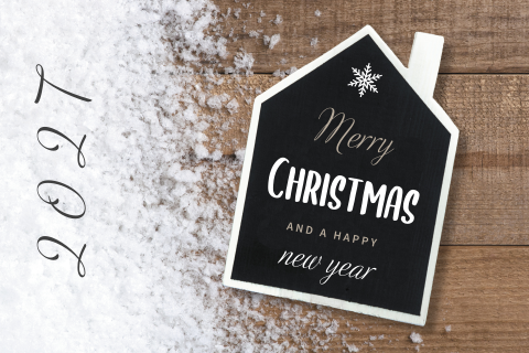 Kerstkaart met krijtbord huisje op hout met sneeuw