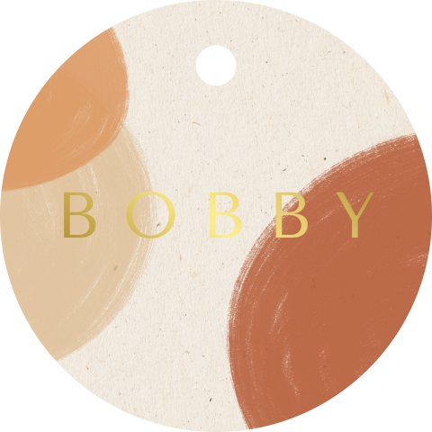 Rond label met bruine bollen en goudfolie
